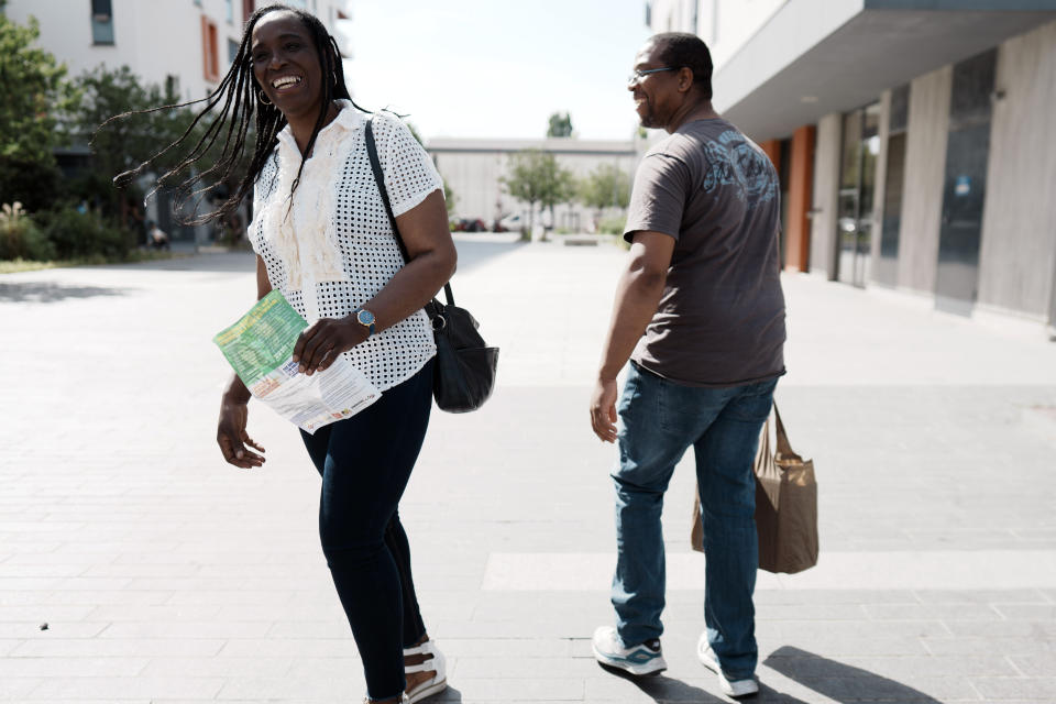 Hard-left candidate, Rachel Keke, left, distributes leaflet to residents of Fresnes, south of Paris, as she campaigns for the second round of the legislative elections, Thursday, June 16, 2022. The former chambermaid, Rachel Keke, took the stand during political rallies across France, to speak about her grueling but successful battle against French hotel giant Accor to obtain better work pay and conditions. (AP Photo/Thibault Camus)