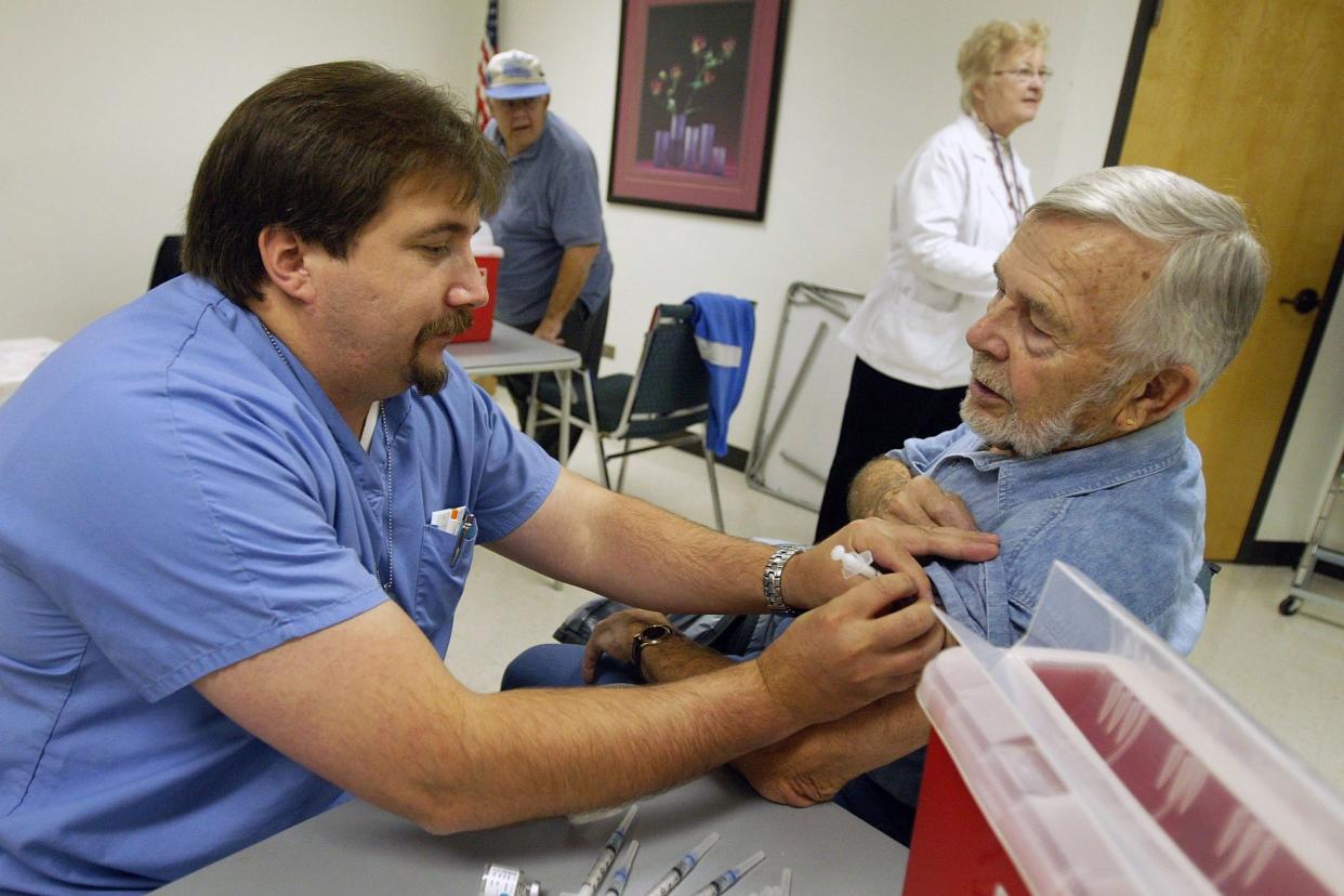 senior receiving flu vaccine