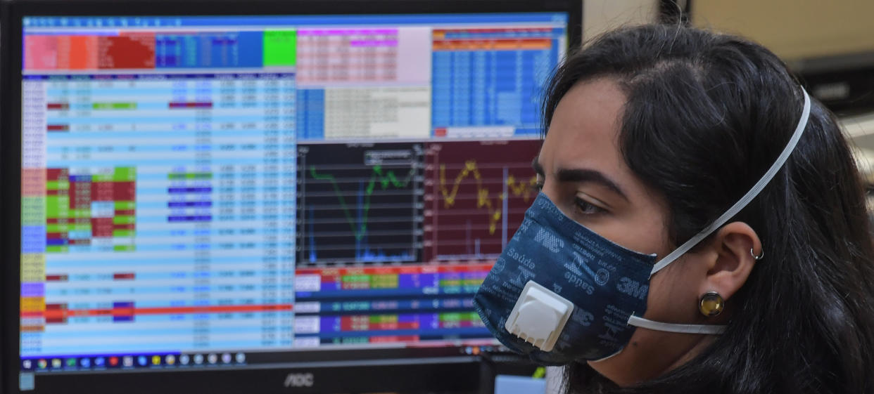 Traders work at the Necton brokerage company in Sao Paulo, Brazil on March 13, 2020. - Brazilian stocks rebounded Friday after days of carnage caused by the coronavirus pandemic, following European markets higher to partially recover their losses. The Sao Paulo stock exchange's Ibovespa index surged more than 14 percent at opening, but then settled to a gain of about seven percent, after losing 14.78 percent Thursda (Photo by NELSON ALMEIDA / AFP) / The erroneous mention[s] appearing in the metadata of this photo by NELSON ALMEIDA has been modified in AFP systems in the following manner: [Traders work at the Necton Brokerage Company] instead of [Traders work at the Sao Paulo stock exchange]. Please immediately remove the erroneous mention[s] from all your online services and delete it (them) from your servers. If you have been authorized by AFP to distribute it (them) to third parties, please ensure that the same actions are carried out by them. Failure to promptly comply with these instructions will entail liability on your part for any continued or post notification usage. Therefore we thank you very much for all your attention and prompt action. We are sorry for the inconvenience this notification may cause and remain at your disposal for any further information you may require. (Photo by NELSON ALMEIDA/AFP via Getty Images)