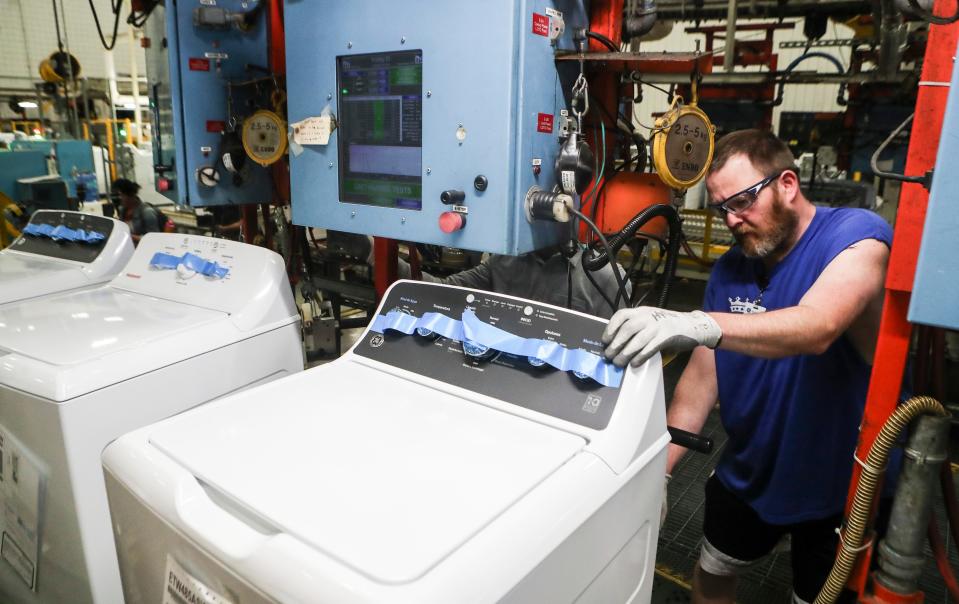 Roy Caswell works on a new GE 4.5 cubic ft. Capacity washing machine featuring a Spanish-language control panel and customized features at GE Appliance Park on April 15, 2024. GE is looking to capitalize on the the growing Spanish-speaking market in the U.S.
