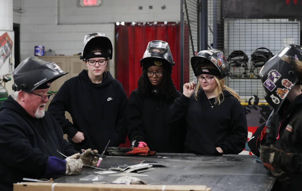 (L-R) Welding instructor Dave McCoy demonstrated the welding process as students Liberty Koerner, Cy'Niya Stafford and Ariana Woosley looked on at the PRP High School in Louisville, Ky. on Mar. 19, 2024