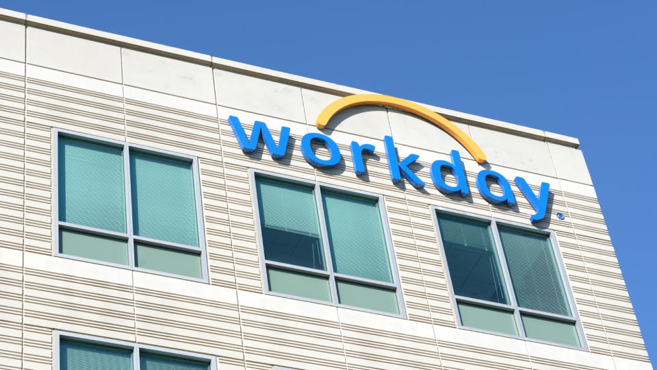 Workday office building with blue and yellow company logo on the side.