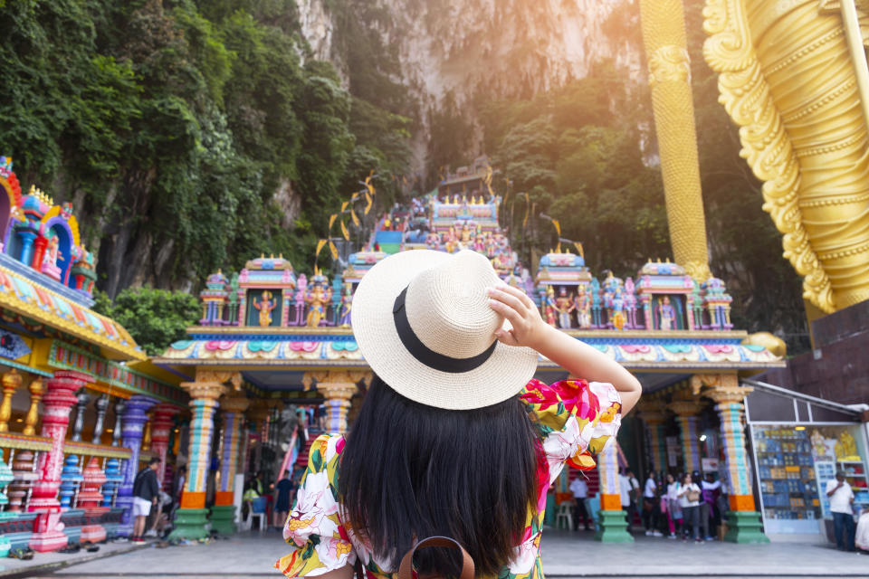 A woman tourist is sightseeing at Batu Caves in Kuala Lumpur, Malaysia.