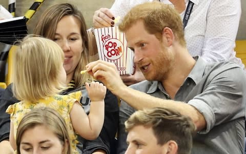 TORONTO, ON - SEPTEMBER 27: Prince Harry (R) sits with David Henson's wife Hayley Henson (L) and daugther Emily Henson at the Sitting Volleyball Finals during the Invictus Games 2017 at Mattamy Athletic Centre - Credit: Chris Jackson/Getty Images