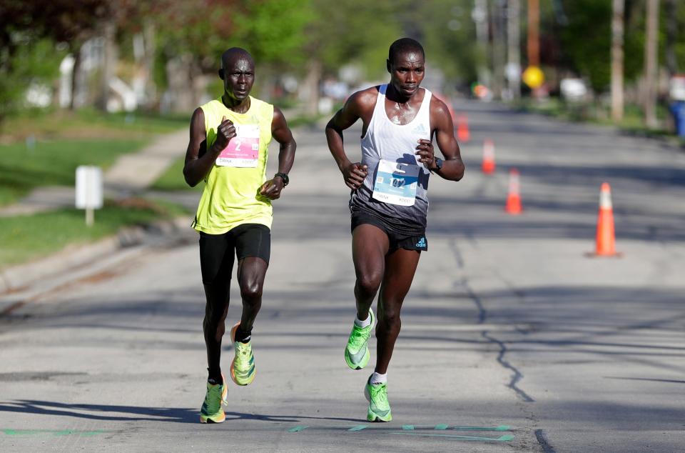 Vincent Toroitich, right, and Luke Kibet, compete in the Cellcom Green Bay Marathon on Sunday. Toroitich won the marathon and Kibet placed second.