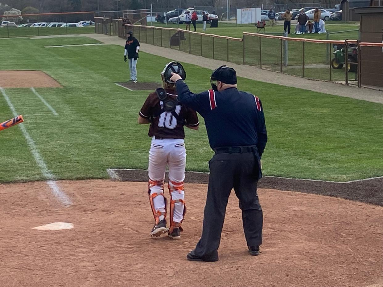 Umpire John Whitson points near home plate in Heath for a baseball game between the Bulldogs and Delaware Hayes Pacers. Whitson will be inducted into the OHSAA Hall of Fame after 50 years of officiating.