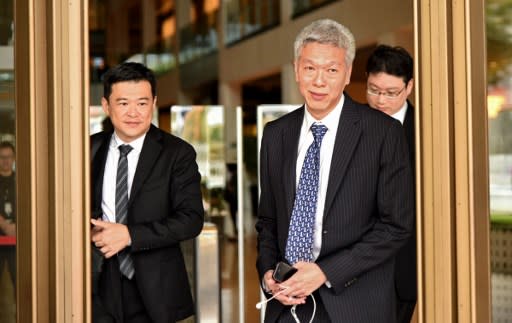 Lee Hsien Yang (right), younger brother of Singapore’s prime minister Lee Hsien Loong, leaves the Supreme court on April 10, 2017. AFP PHOTO / ROSLAN RAHMAN