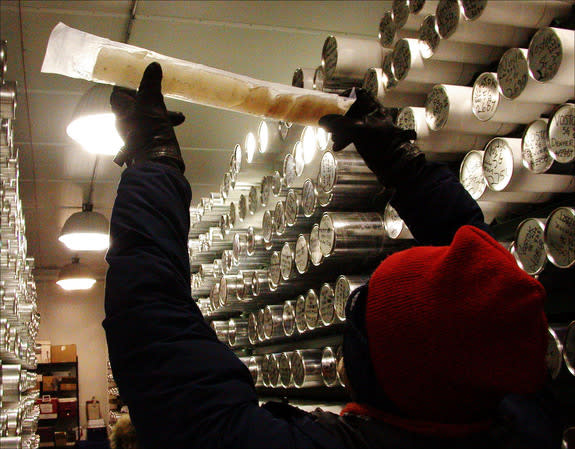 Eric Cravens, assistant curator at the National Ice Core Lab in Littleton, Colo., holds up a piece of ice taken from above Lake Vostok in Antarctica.