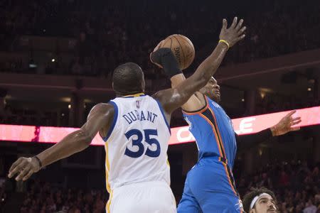 January 18, 2017; Oakland, CA, USA; Oklahoma City Thunder guard Russell Westbrook (0, right) dunks the basketball past Golden State Warriors forward Kevin Durant (35) during the third quarter at Oracle Arena. Mandatory Credit: Kyle Terada-USA TODAY Sports