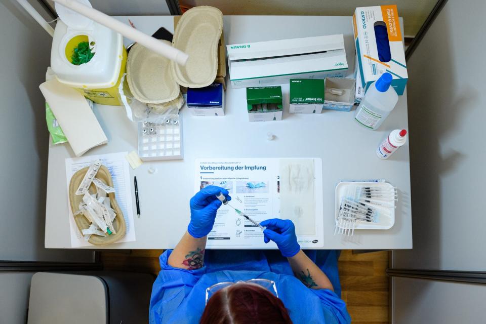 Medical staff prepare a vial of the Pfizer/BioNTech Comirnaty vaccine against COVID-19 in Erfurt, Germany, on Sept. 15.