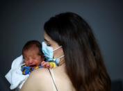 FILE PHOTO: Emmanuelle Lteif Khnaisser who was in labour at the moment of the Beirut port blast, holds her baby George at the family home in Jal el-Dib