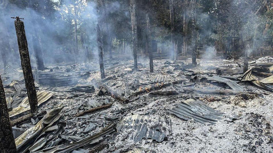 The remains of houses are seen in a village outside the town of Pasuang in Myanmar's eastern state of Kayah on Sunday, June 25, 2023, after what villagers and other witnesses said was an airstrike by planes of the military government. The military government use air and ground attacks to try to crush the armed resistance that arose after the military seized power from the elected government of Aung San Suu Kyi in February 2021. Fighting has been fierce in southern Kayah, where members of an army-established ethnic Karenni militia recently defected en masse to the resistance side.(Free Burma Rangers via AP)