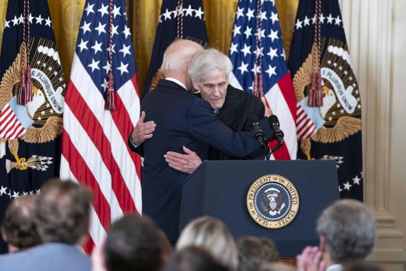 President Joe Biden embraces Steve Hadfield, a North Carolina resident impacted by drug prices, during an event on lowering healthcare costs in the East Room of the White House on Tuesday. Photo by Bonnie Cash/UPI