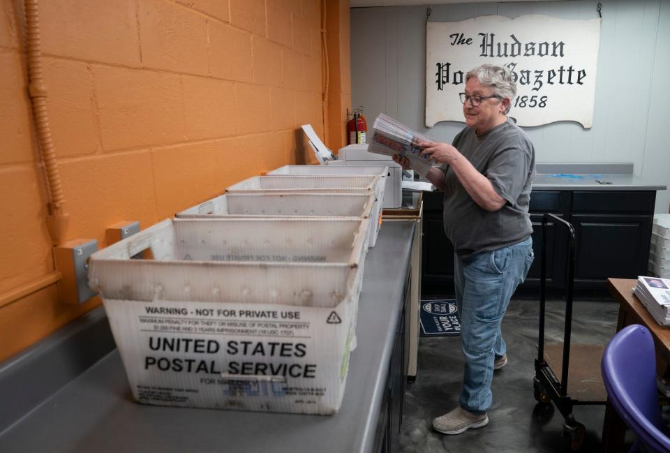 Barbara Ireland, 72, gathers bundles of the Hudson Post-Gazette for delivery on Tuesday, July 2, 2024 inside the newspaper's office.