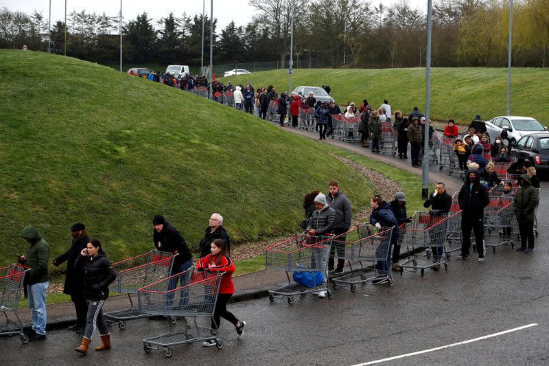 FILE PHOTO: People queue outside of a Costco store in Watford