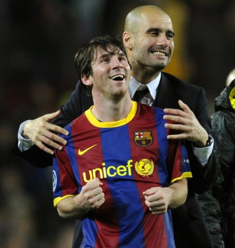 Barcelona's coach Josep Guardiola (right) celebrates with Argentinian forward Lionel Messi after the Champions League semi-final second leg football match between Barcelona and Real Madrid at the Camp Nou stadium in Barcelona on May 3, 2011. Guardiola, architect of one the greatest eras in the club's history, has reportedly told players he is leaving at the end of this season