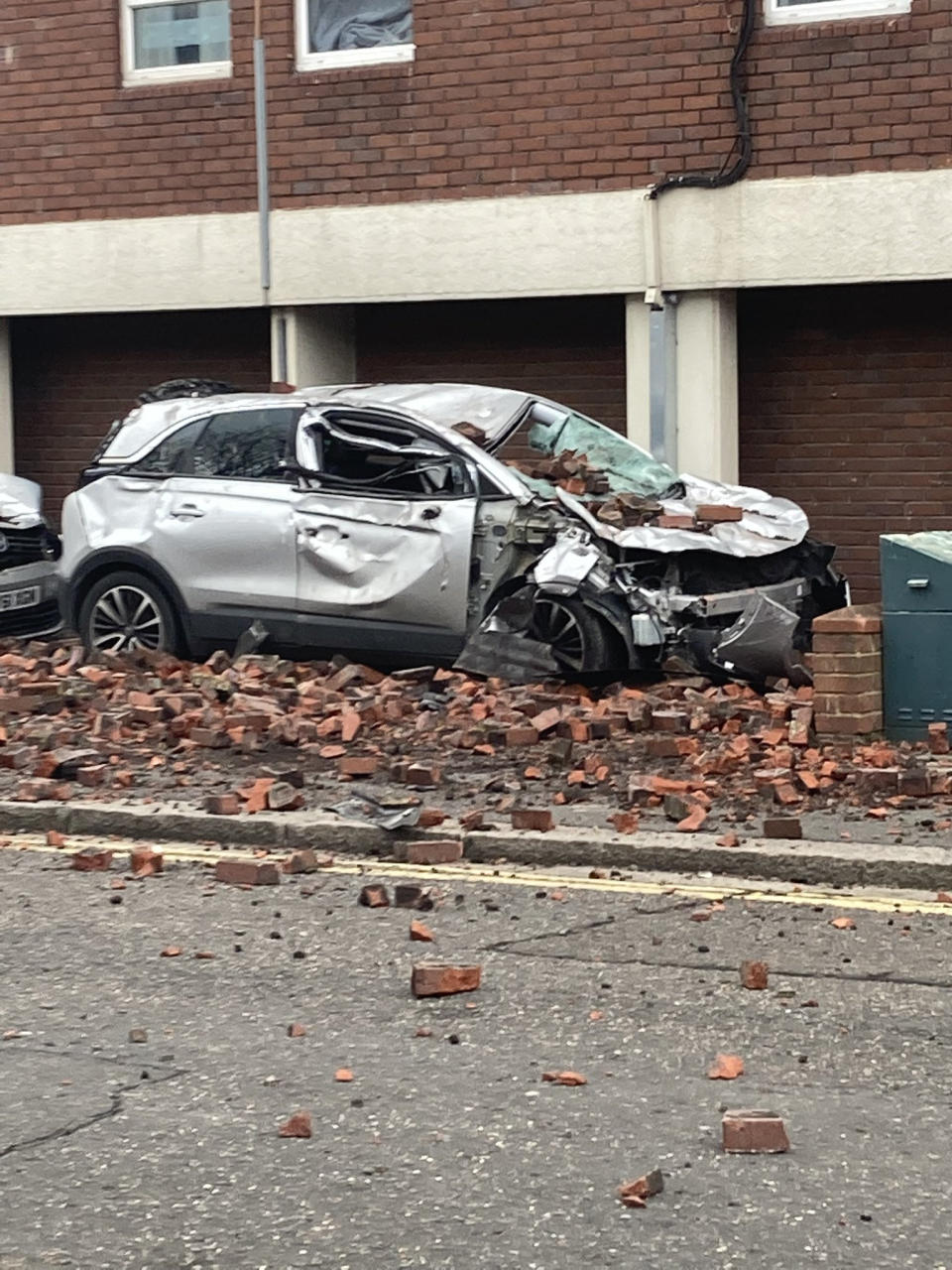 Damage to a car caused by falling bricks from a tower block during Storm Eunice. (PA)