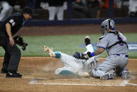 New York Mets catcher Tomas Nido (3) tags out Miami Marlins' Jon Berti (5) during the fifth inning of a baseball game, Friday, March 31, 2023, in Miami. (AP Photo/Michael Laughlin)