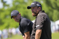 Rory McIlroy, of Northern Ireland, waits his torun on the 18th green with his teammate Shane Lowry, of Ireland, right, during the second round of the PGA Zurich Classic golf tournament at TPC Louisiana in Avondale, La., Friday, April 26, 2024. (AP Photo/Gerald Herbert)