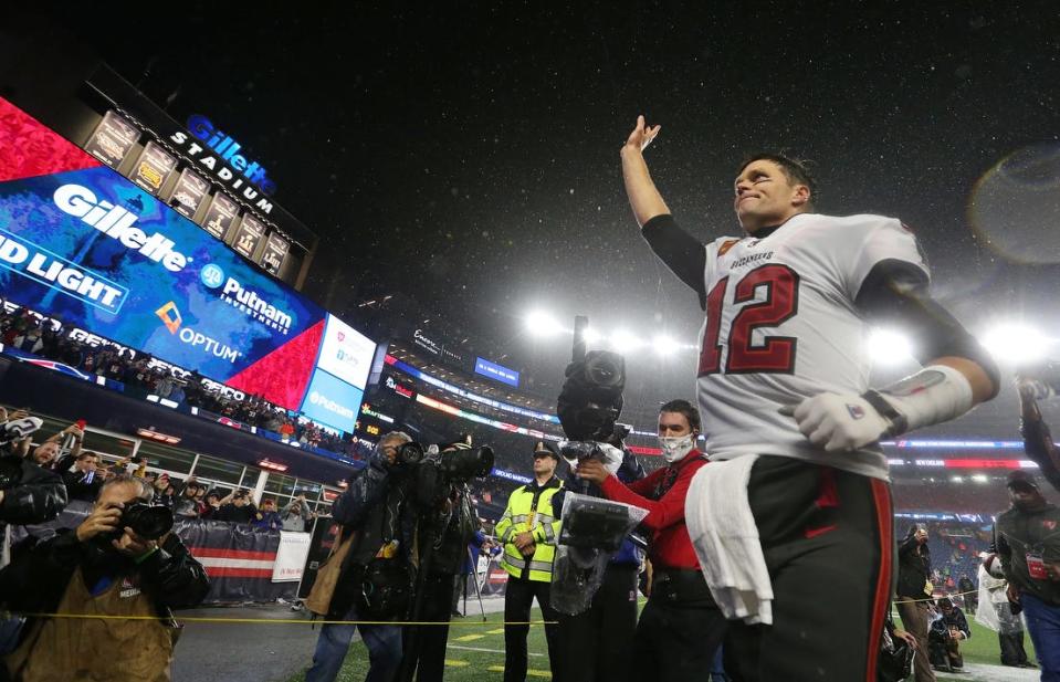 Tom Brady comes off the field and waves to fans after the Buccaneers' 19-17 win over the Patriots on Sunday night.