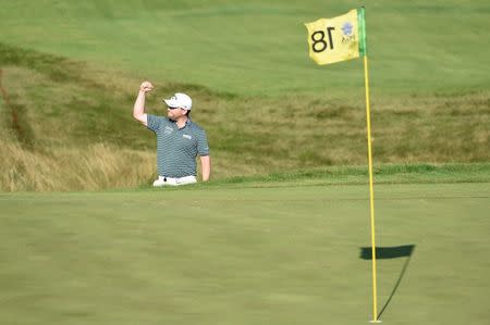 Aug 15, 2015; Sheboygan, WI, USA; Branden Grace reacts after his bunker shot runs into the hole for a birdie on the 18th hole during the third round of the PGA Championship golf tournament at Whistling Straits. Mandatory Credit: Michael Madird-USA TODAY Sports