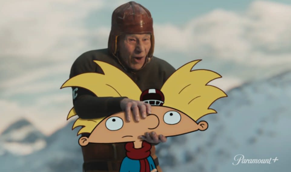  Patrick Stewart dressed in an old-timey football outfit holds Arnold's head from Hey Arnold as he plans to throw the cartoon child in a Super Bowl 2024 ad for Paramount Plus. 
