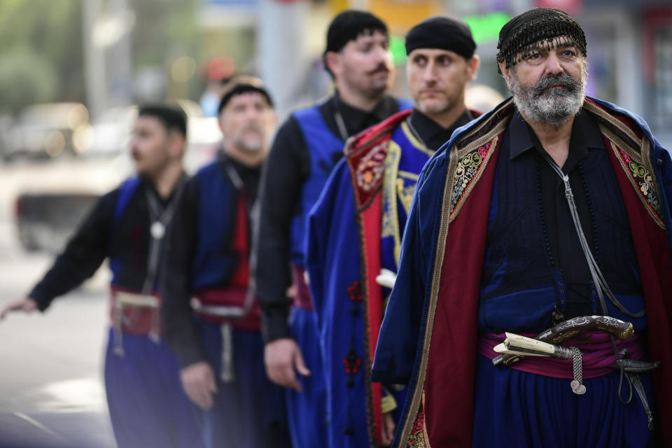 Men in traditional dress from the island of Crete attend a procession , ahead of the burial of the late Greek composer, Mikis Theodorakis in Chania, Crete island, Greece, Thursday, Sept. 9 2021. Theodorakis died Thursday, Sept. 2, 2021 at 96. He penned a wide range of work, from somber symphonies to popular TV and film scores, including for "Serpico" and "Zorba the Greek." He is also remembered for his opposition to the military junta that ruled Greece from 1967-1974, when he was persecuted and jailed and his music outlawed. (AP Photo/Michael Varaklas)