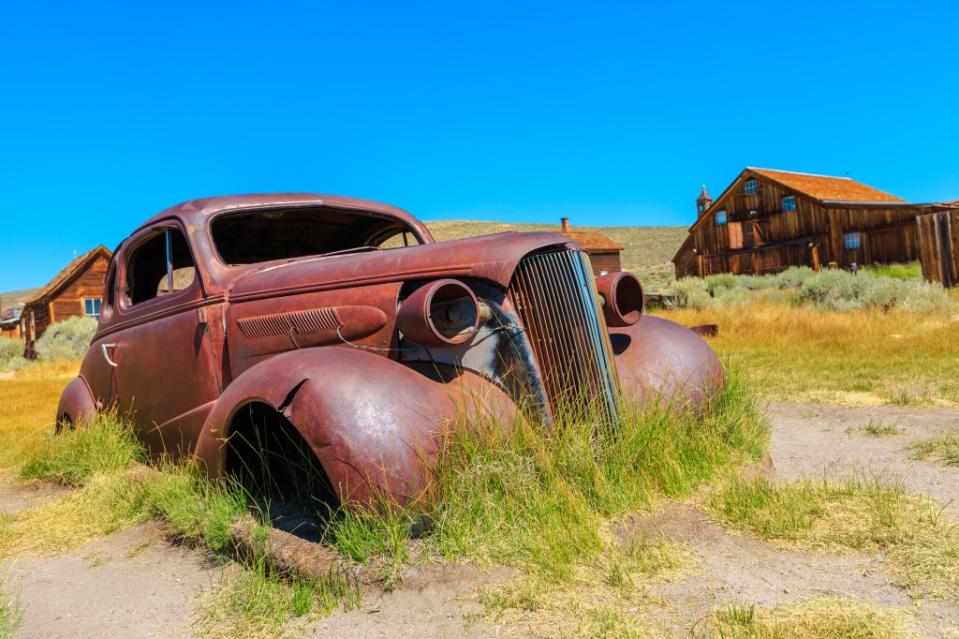 front view of rusty car wreck of the 1930s, in Bodie State historic park, Californian Ghost Town of 1800s via Getty Images