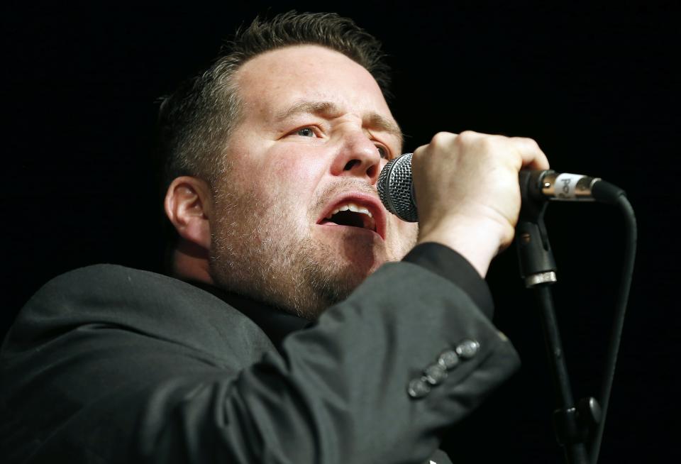 Ken Casey performs with Dropkick Murphys during the annual St. Patrick's Day Breakfast in Boston, Sunday, March 16, 2014. (AP Photo/Michael Dwyer)