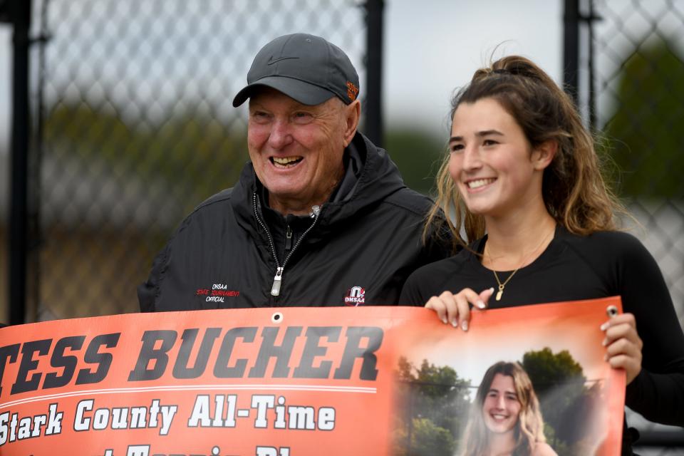 Hoover senior Tess Bucher, joined by her coach Ryan Shaffer, is honored by her team after winning the girls tennis Division I sectional final to become Stark County's all-time winningest player, Saturday, Oct. 7, 2023, at Jackson Park Courts.