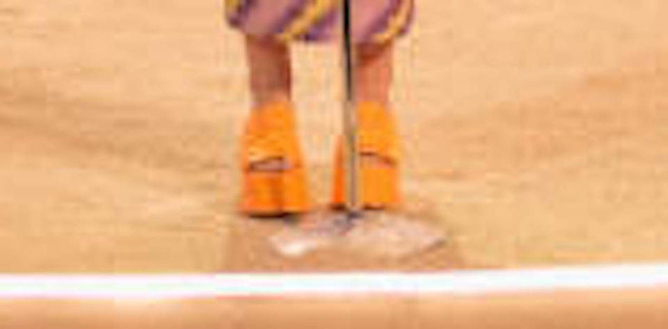 A closer look at Lorde’s orange wedge platform sandals. - Credit: CBS