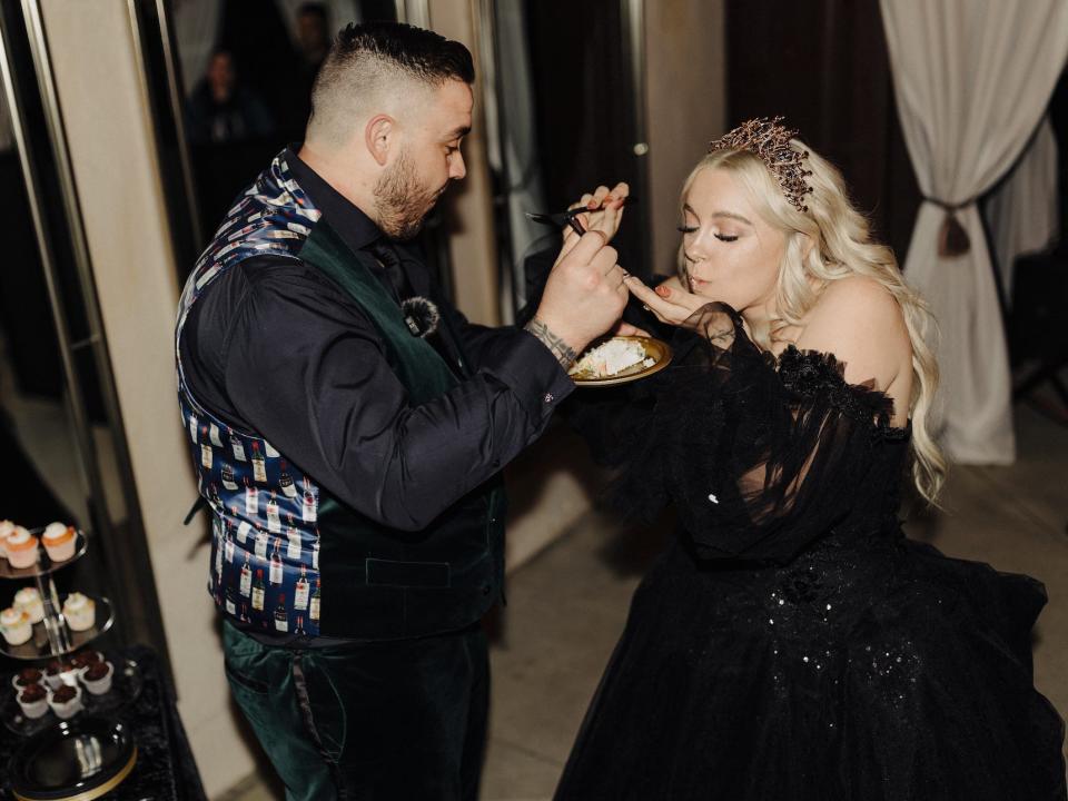 A bride and groom eat cake on their wedding day.