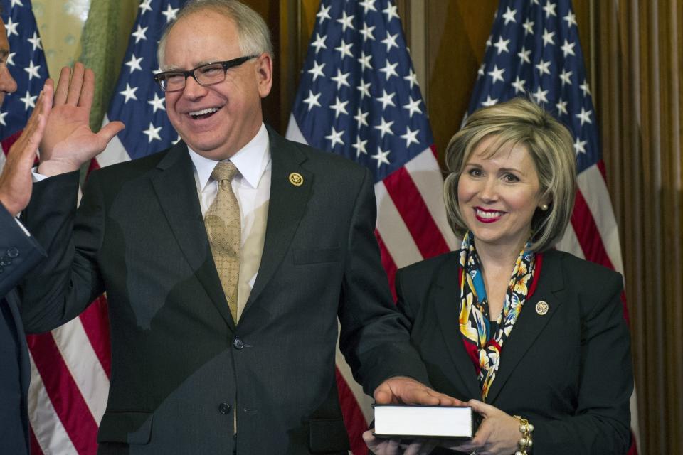 House Speaker John Boehner of Ohio administers a ceremonial re-enactment of the House oath-of-office to Rep. Tim Walz, D-Minn., accompanied by his his wife Gwen, Tuesday, Jan. 6, 2015, on Capitol Hill in Washington.