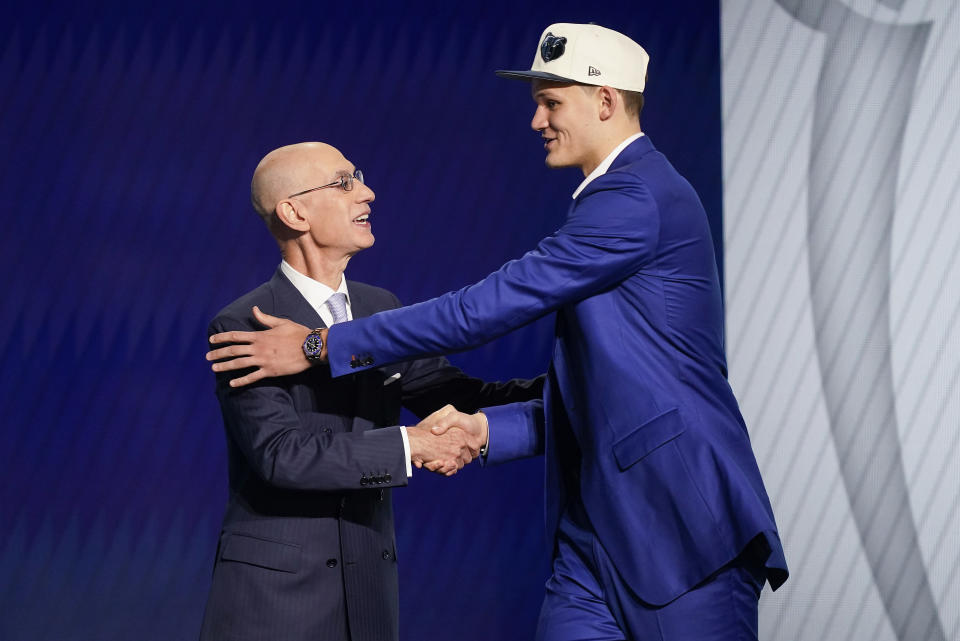 Walker Kessler, right is congratulated by NBA Commissioner Adam Silver after being selected 22nd overall by the Memphis Grizzlies in the NBA basketball draft, Thursday, June 23, 2022, in New York. (AP Photo/John Minchillo)