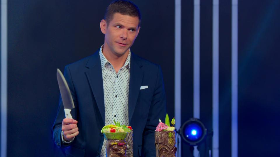 Host and "Saturday Night Live" cast member Mikey day prepares to cut into something that might be a baked good on "Is it Cake?"