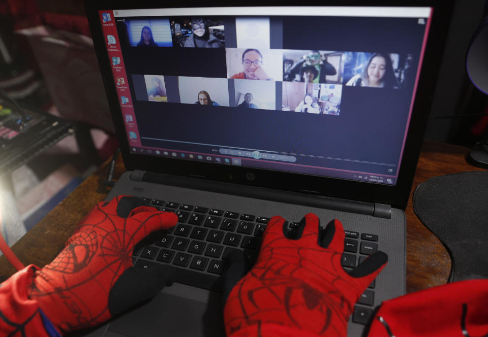 Art teacher Jorge Manolo Villarroel, wearing a Spider-Man costume, teaches an online class from his home, amid the new coronavirus pandemic in La Paz, Bolivia, Tuesday, June 9, 2020. His classes have become so popular that siblings fight for the laptop to learn from this costumed teacher. (AP Photo/Juan Karita)