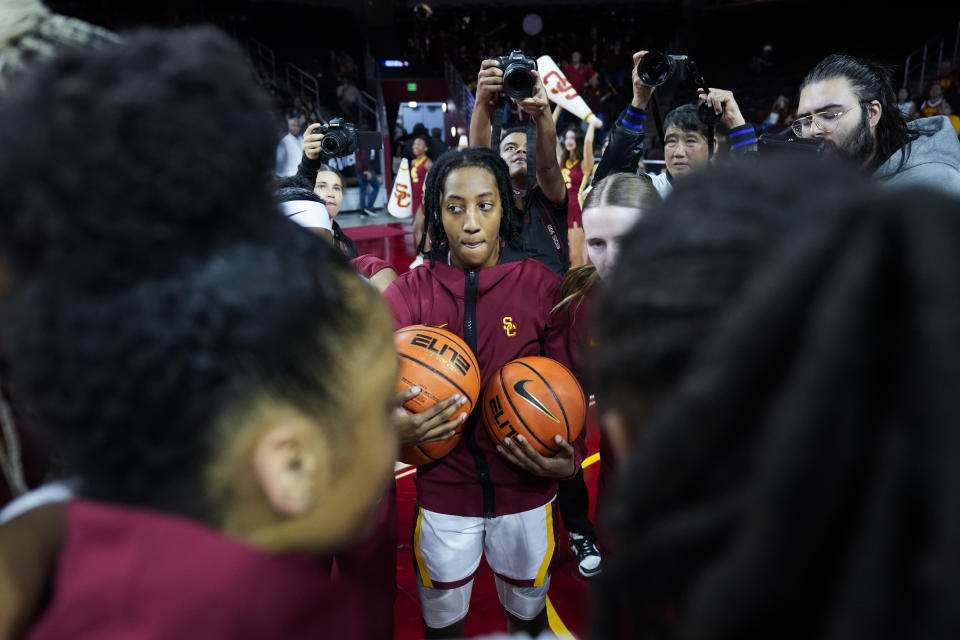 Southern California guard Aaliyah Gayles huddles with teammates before an NCAA college basketball game against Washington in Los Angeles, Sunday, Jan. 28, 2024. (AP Photo/Ashley Landis)