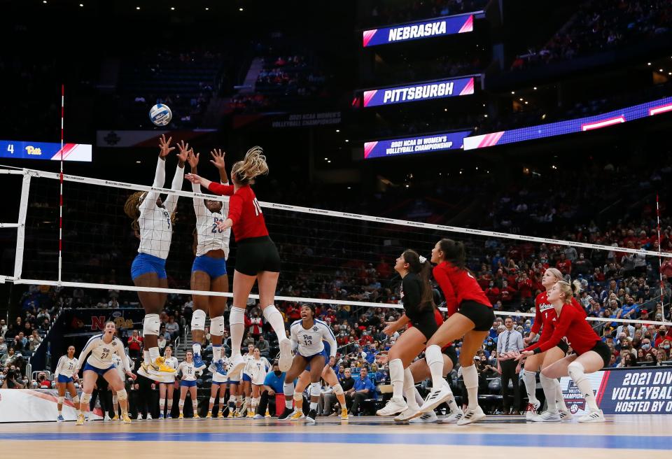 Nebraska Cornhuskers outside hitter Madi Kubik (10) hits over Pitt Panthers Chinaza Ndee (5) and Chiamaka Nwokolo (20) during the NCAA volleyball championship final four at Nationwide Arena in Columbus on Friday, Dec. 17, 2021. 