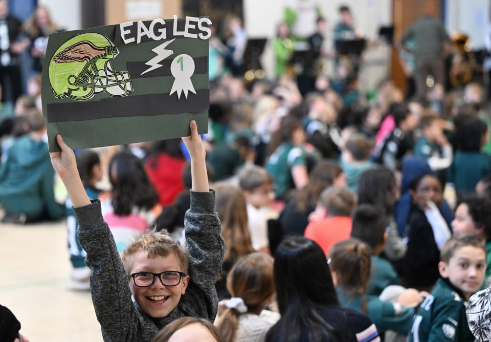 Willy Stern, a fifth-grader at Richland Elementary, shows his Eagles spirit while holding a sign in the air Wednesday, Feb. 1, 2023, at the school in Richland Township. Eagles punt returner Britain Covey visited the school and answered questions from students ahead of the team's Super Bowl appearance against the Kansas City Chiefs.