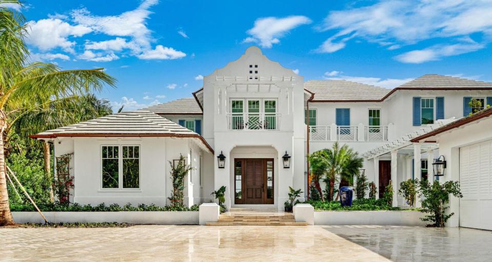 A new house at 584 Island Drive in Palm Beach has architecture with Dutch Colonial influences, including a scalloped gable at the front entrance. The price was just dropped by about $5.5 million to $39.999 million