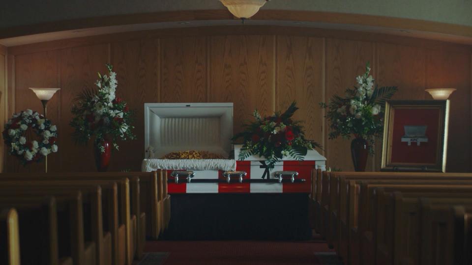 KFC Canada funeral for fries. An image of an open coffin that looks like a KFC box containing fries