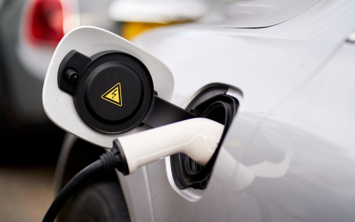 An electric car plugged in to a charger