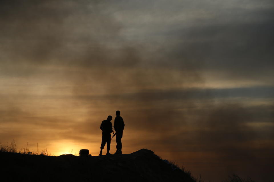 Israeli soldiers stand near Israel and Gaza border, Israel, Friday, Oct. 5, 2018. The Israeli military said Thursday it was bolstering its forces along the Gaza border ahead of another expected explosive Hamas-orchestrated protest. (AP Photo/Ariel Schalit)