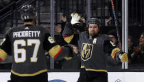 Vegas Golden Knights right wing Mark Stone, right, celebrates with left wing Max Pacioretty after scoring against the Tampa Bay Lightning during the second period of an NHL hockey game Thursday, Feb. 20, 2020, in Las Vegas. (AP Photo/Isaac Brekken)