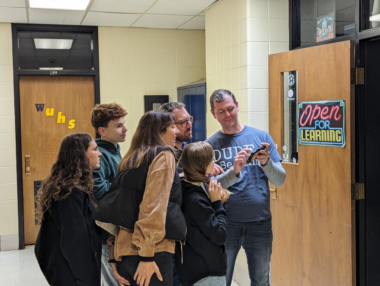 United High School boys soccer coach Curtis Jones, far right, shows a 1995 team picture to Bruno Jouffroy, man in glasses, as Jouffroy’s wife and children look on. Jouffroy was a foreign exchange student from France in 1995, and was Jones’ teammate at the time. Jouffroy’s wife, LaRochelle, and their three children, Noélie, Adam and Lisa, toured the Salem school along with Jouffroy.