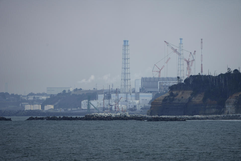 The Fukushima Daiichi nuclear power plant sits in coastal towns of both Okuma and Futaba, as seen from the Ukedo fishing port in Namie town, northeastern Japan, Wednesday, March 2, 2022. Eleven years after the Fukushima Daiichi nuclear power plant was ravaged by a meltdown following a massive earthquake and tsunami, the plant now looks like a sprawling construction site. Most of the radioactive debris blasted by the hydrogen explosions has been cleared and the torn buildings have been fixed. (AP Photo/Hiro Komae)