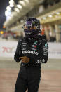 Mercedes driver Lewis Hamilton of Britain, right, celebrates after winning the pole position after the qualifying session at the Formula One Bahrain International Circuit in Sakhir, Bahrain, Saturday, Nov. 28, 2020. (Hamad Mohammed, Pool via AP)