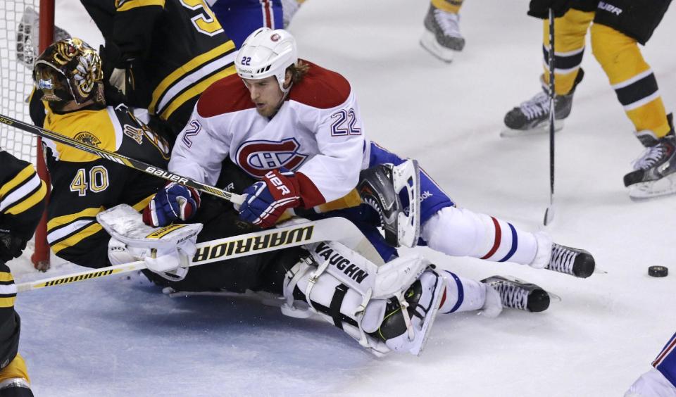 Montreal Canadiens right wing Dale Weise (22) knocks over Boston Bruins goalie Tuukka Rask (40) after a shot on goal during the third period of Game 5 in the second-round of the Stanley Cup hockey playoff series in Boston, Saturday, May 10, 2014. (AP Photo/Charles Krupa)