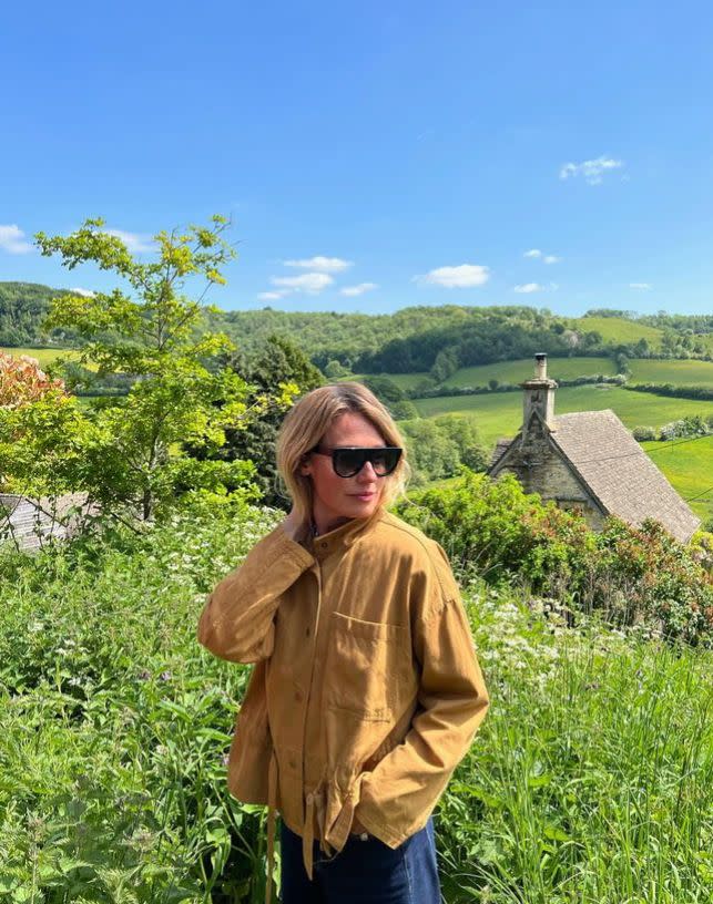 Cat Deeley in a field in a jacket and denim skirt