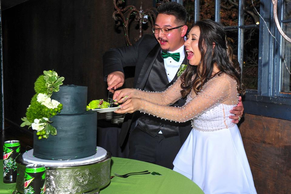 Nicolas Enriquez, left, and Alina Ibarra cut into their wedding cake at The Foundry for the Hard Mountain Dew wedding on Nov. 15. The iconic drink brand handled everything for the couple's wedding for free, from the ceremony to the refreshments to the guest list.